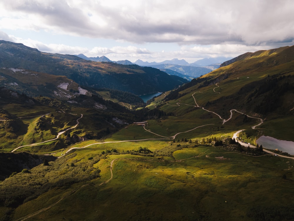 an aerial view of a winding road in the mountains