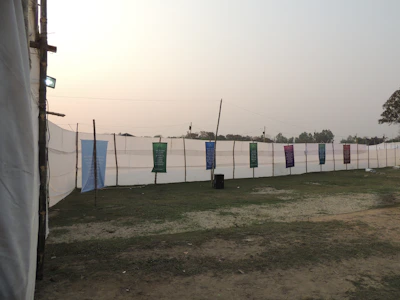 A team assembling a sturdy promotional platform outdoors with bright banners.