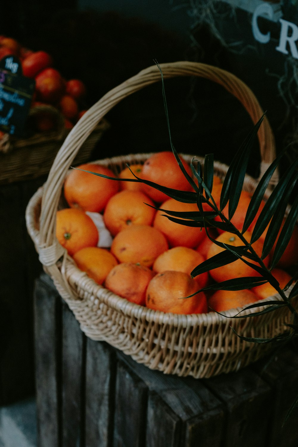a basket full of oranges sitting on a table