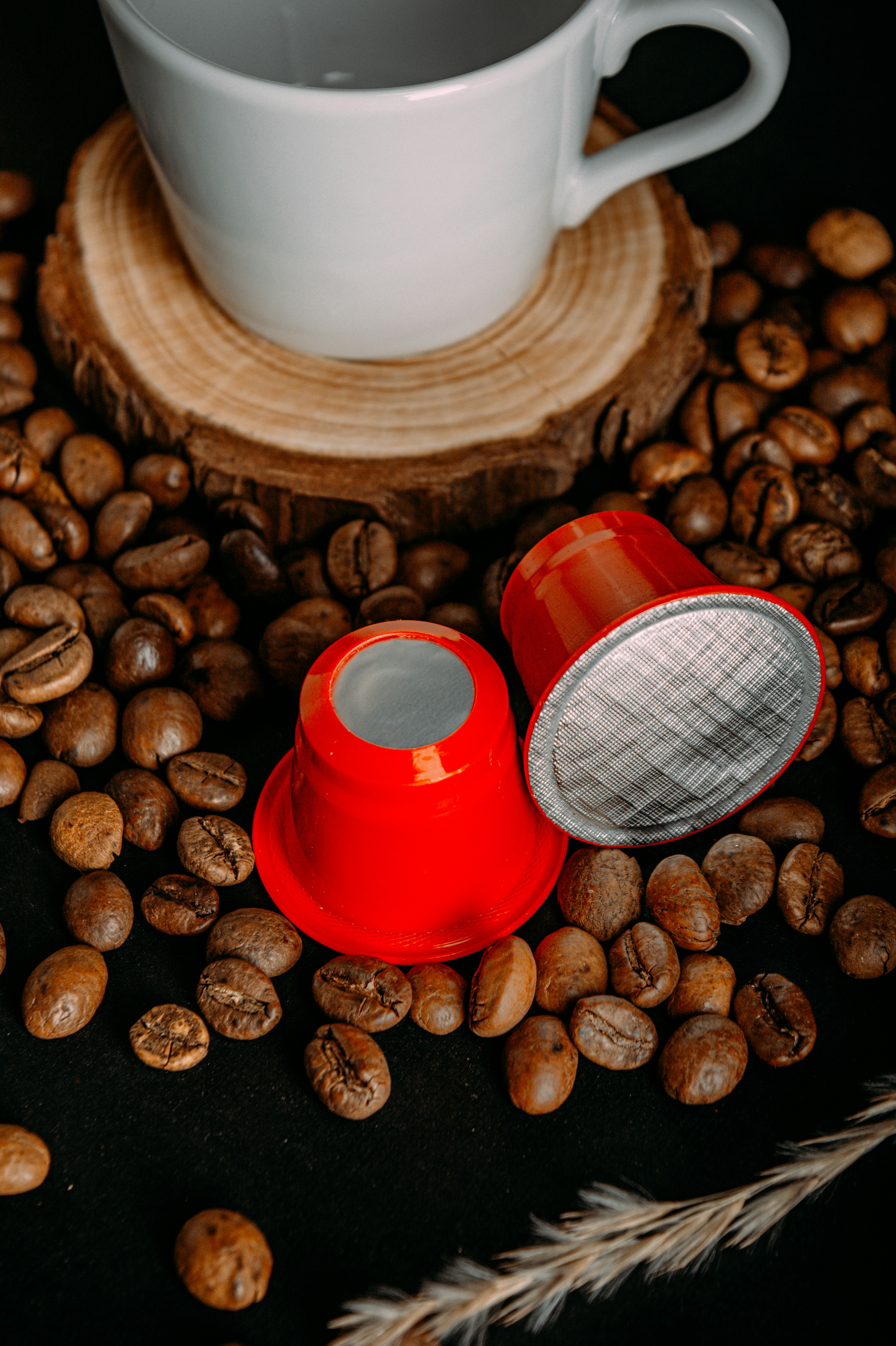 a cup of coffee next to some coffee beans