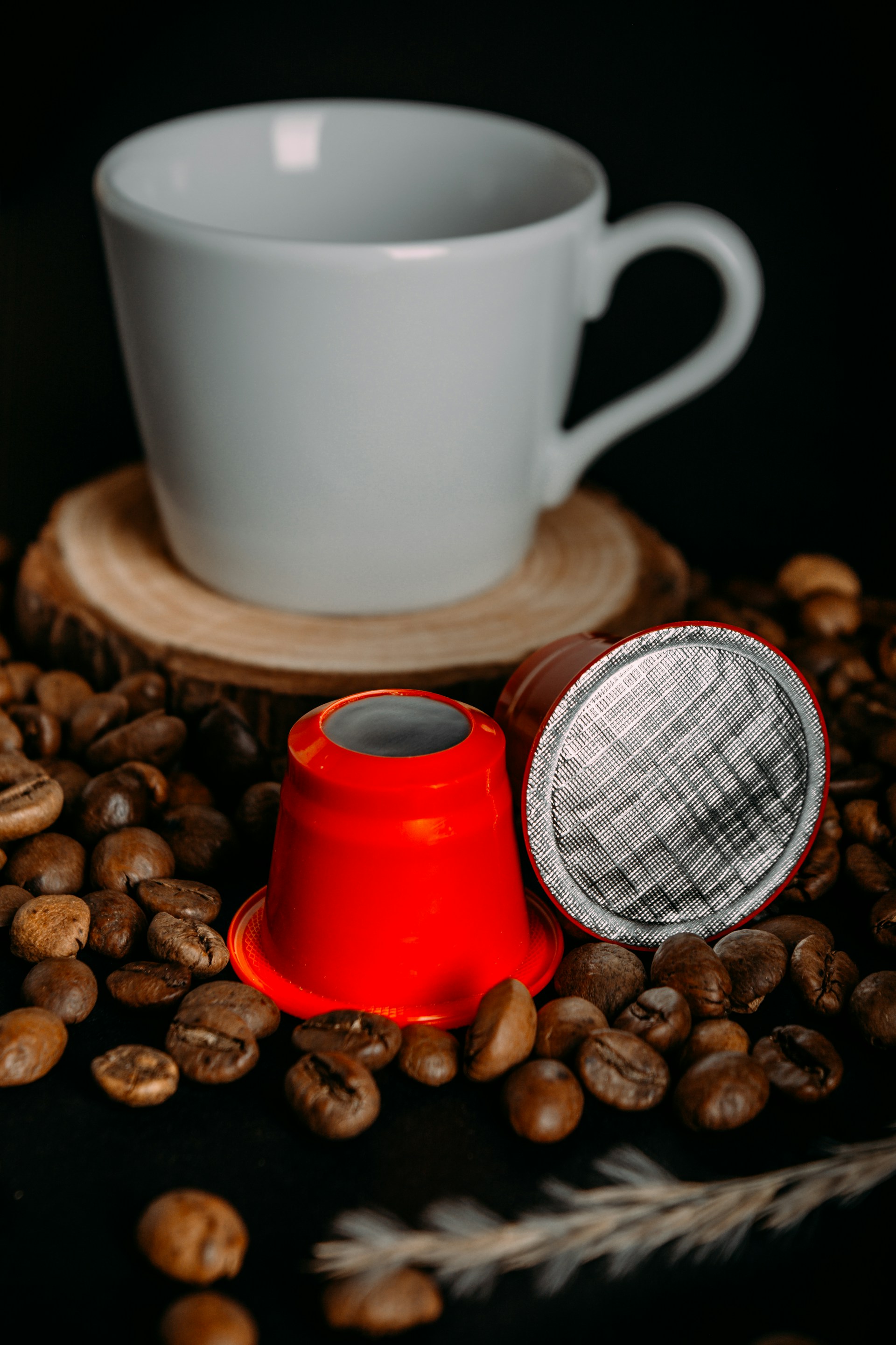 a cup of coffee next to some coffee beans
