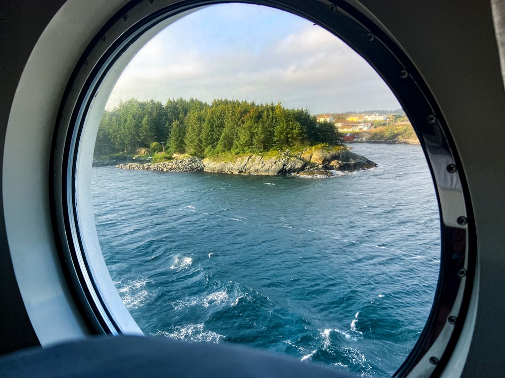 a view of a body of water through a porthole window