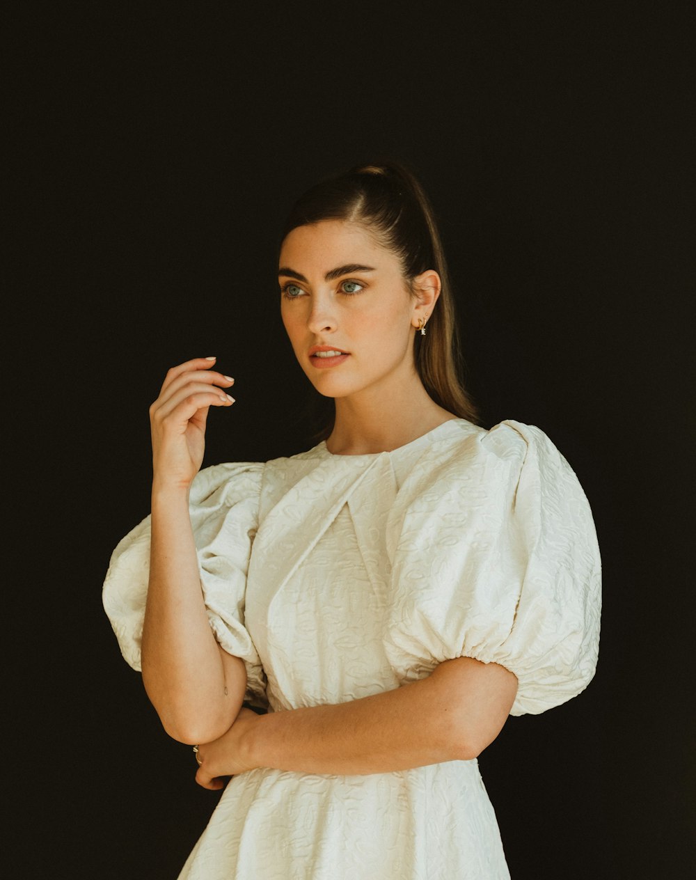 a woman in a white dress posing for a picture