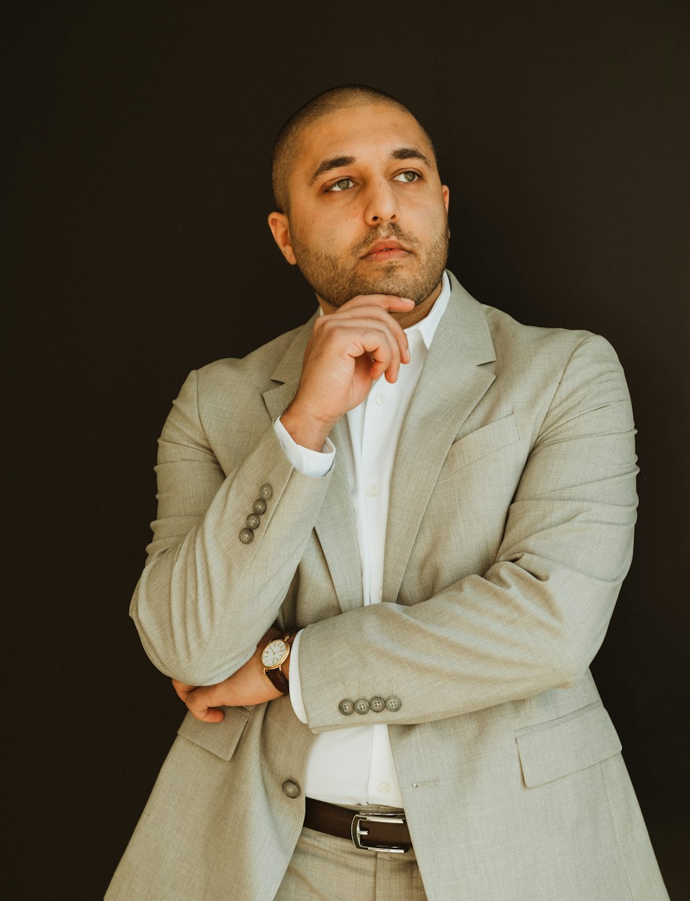 a man in a suit posing for a picture