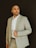 a man in a suit is posing for a picture