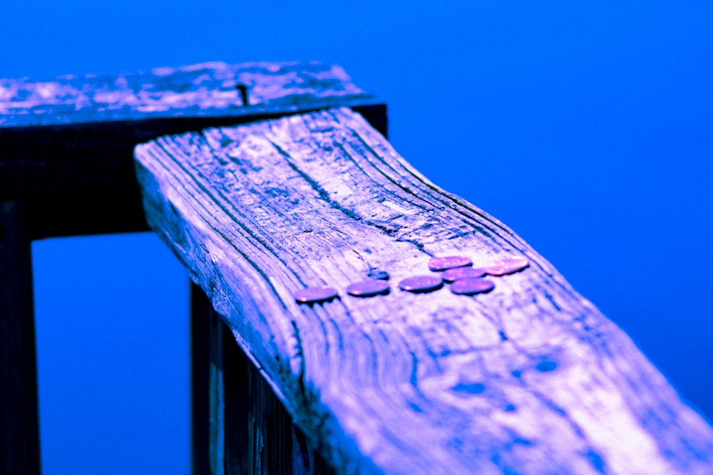 a close up of a wooden bench with buttons on it