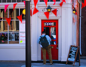 a man standing in front of a red door