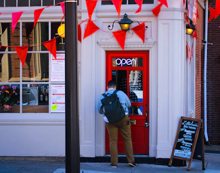 a man standing in front of a red door