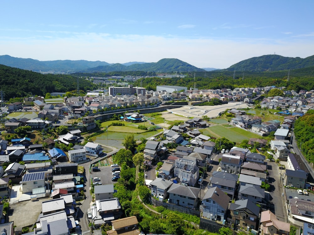 an aerial view of a city with mountains in the background