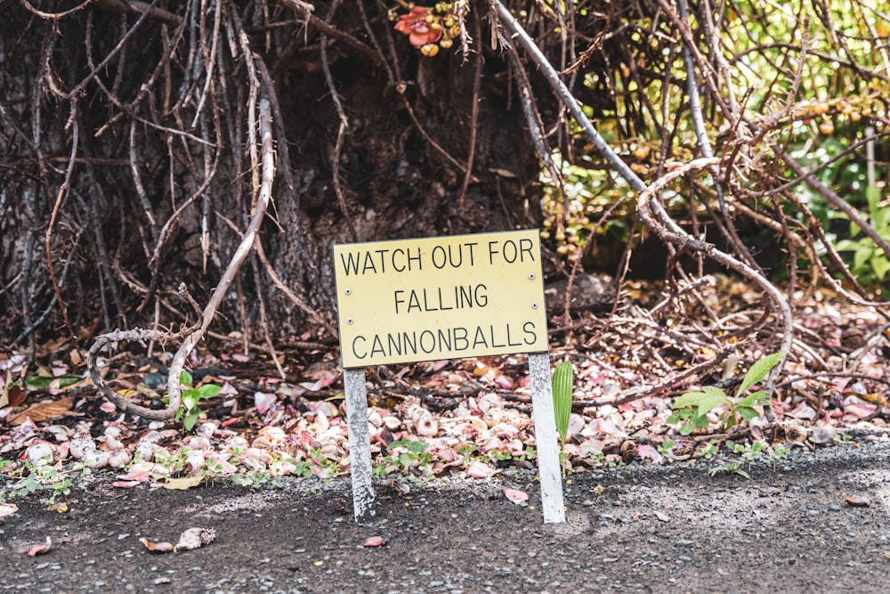 a yellow sign sitting on the side of a road