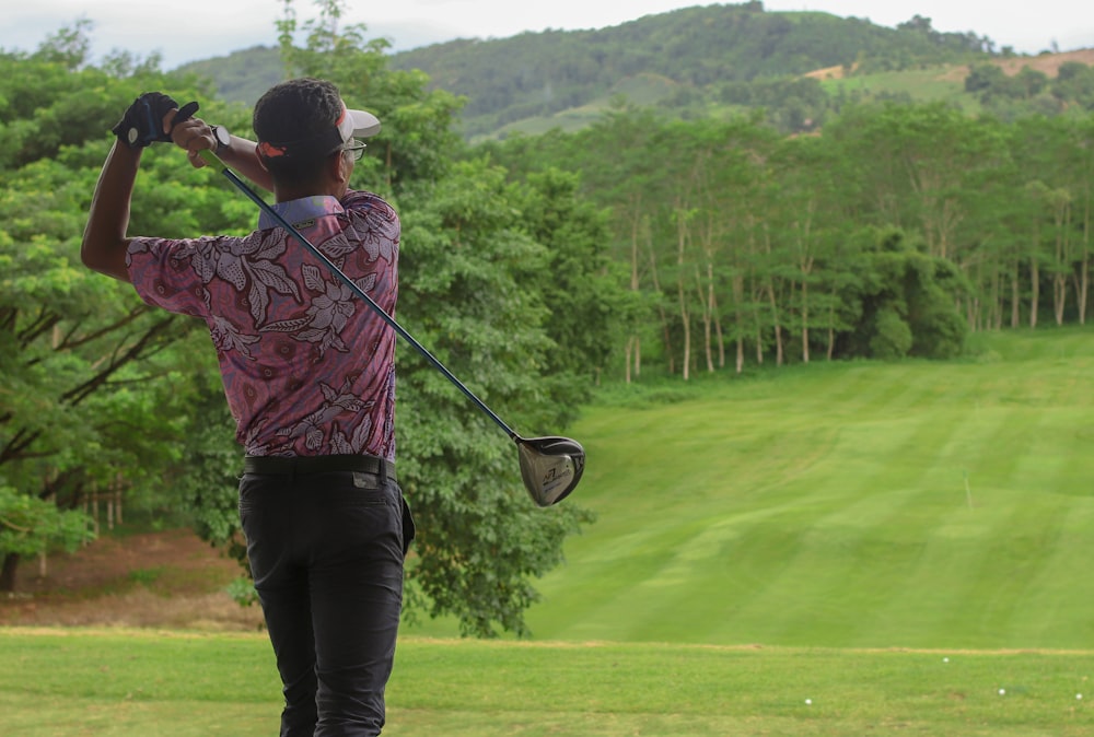 a man swinging a golf club on a golf course