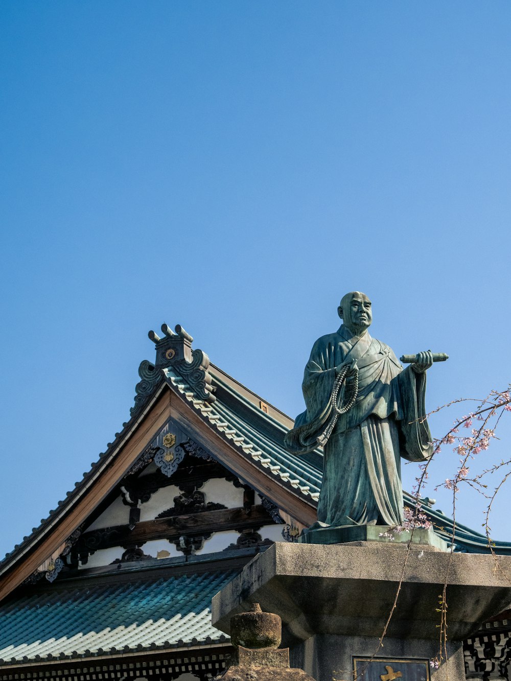 a statue on top of a building with a sky background