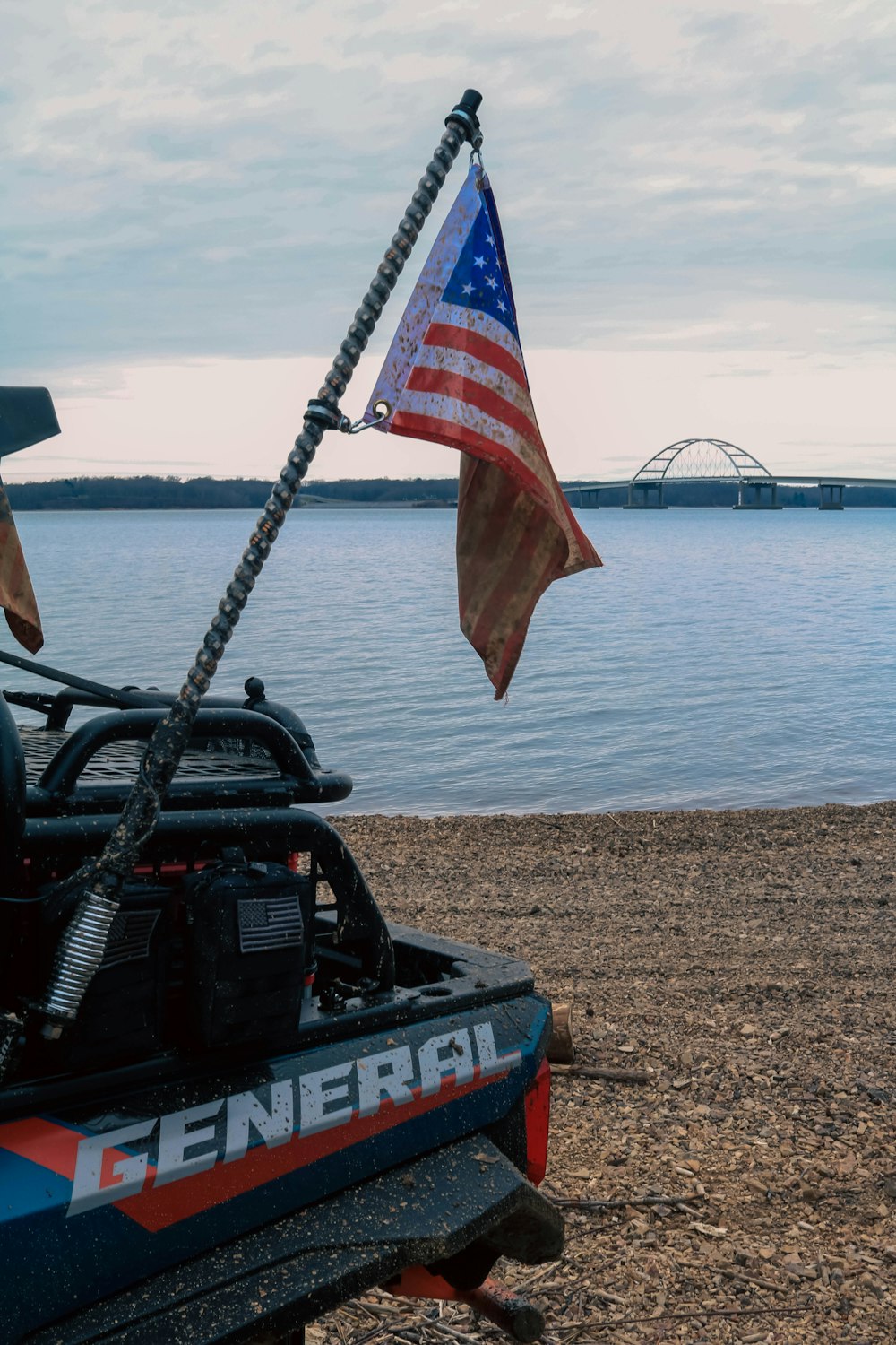 a jeep with an american flag on top of it