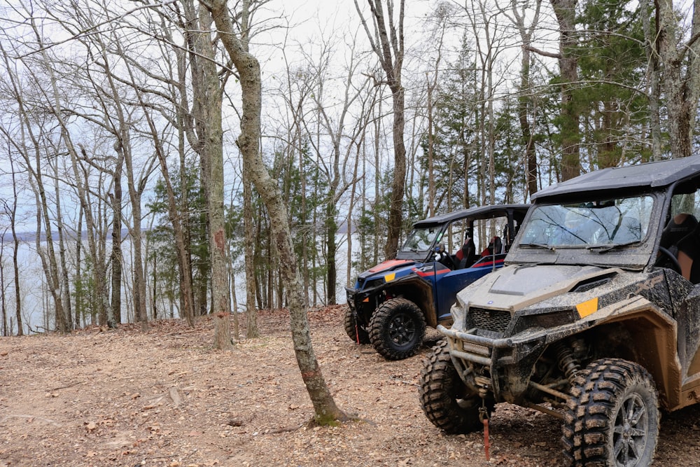 a group of people riding on four wheelers in the woods