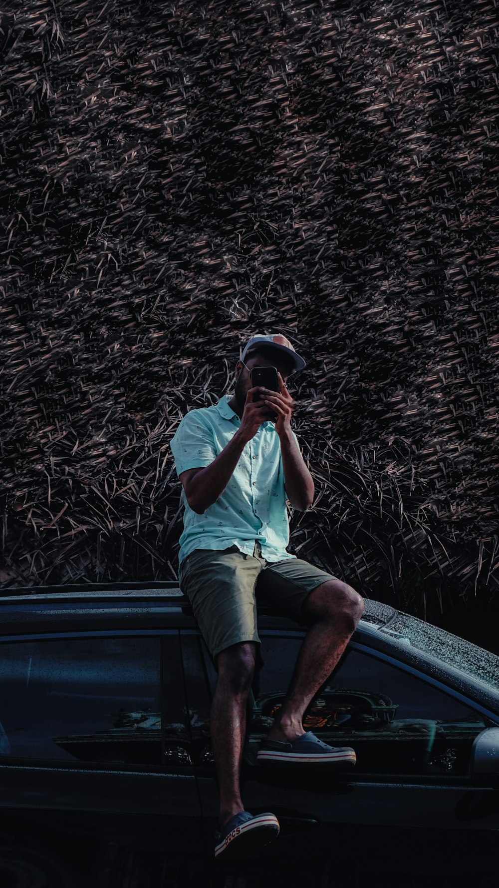 a man sitting on the hood of a car