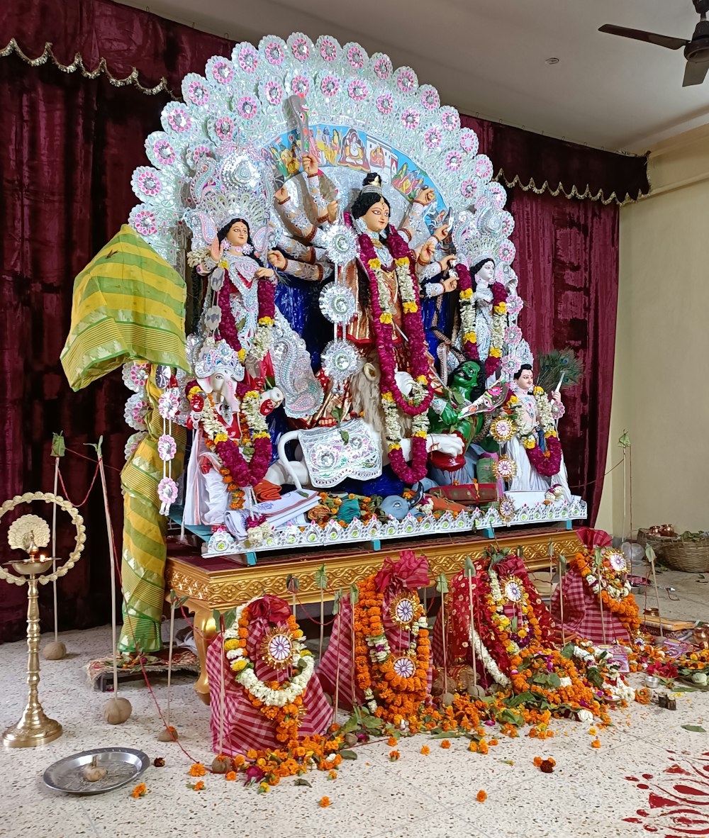 a statue of hindu deities on display in a room