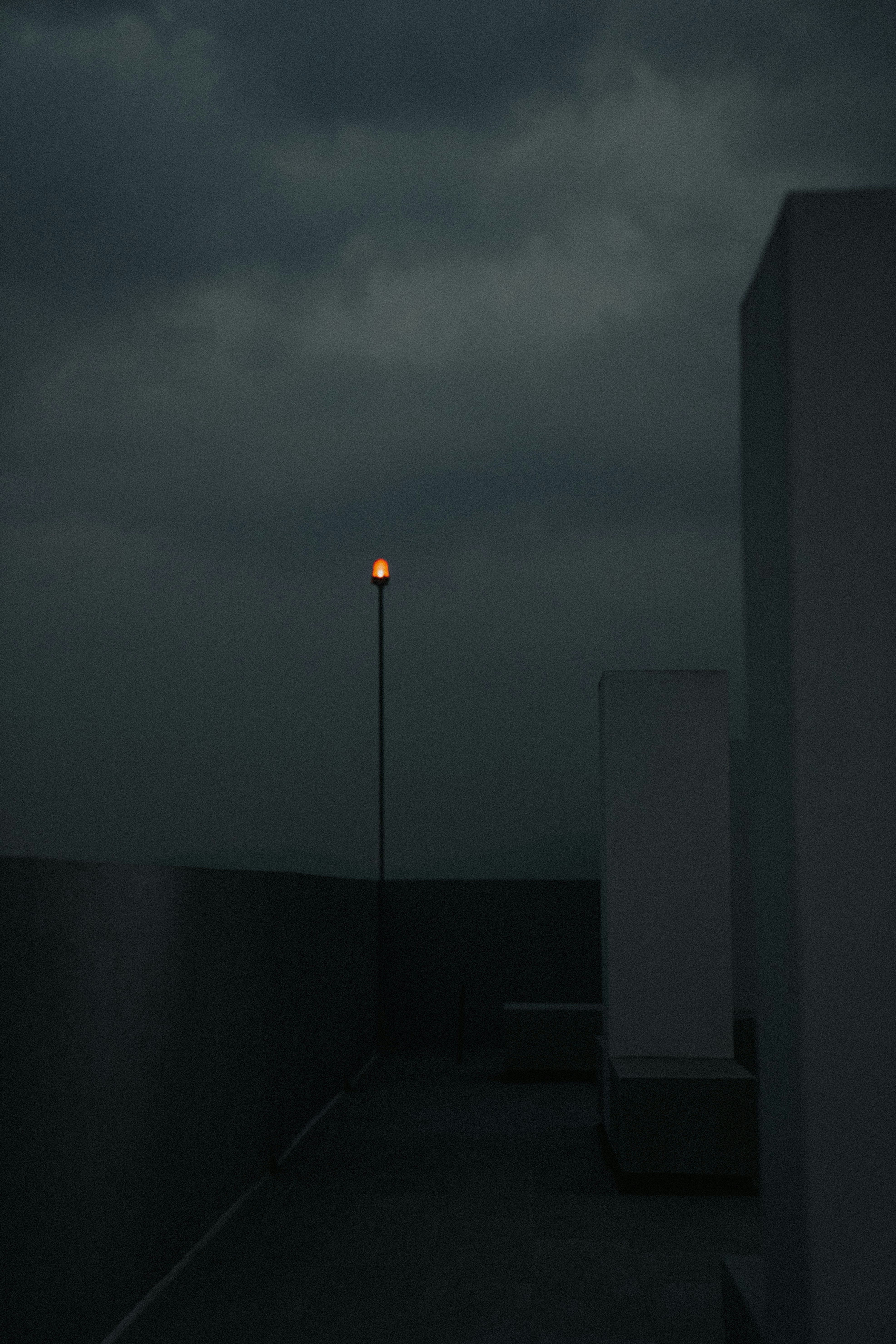 A street light sitting on the side of a building photo – Free Grey ...