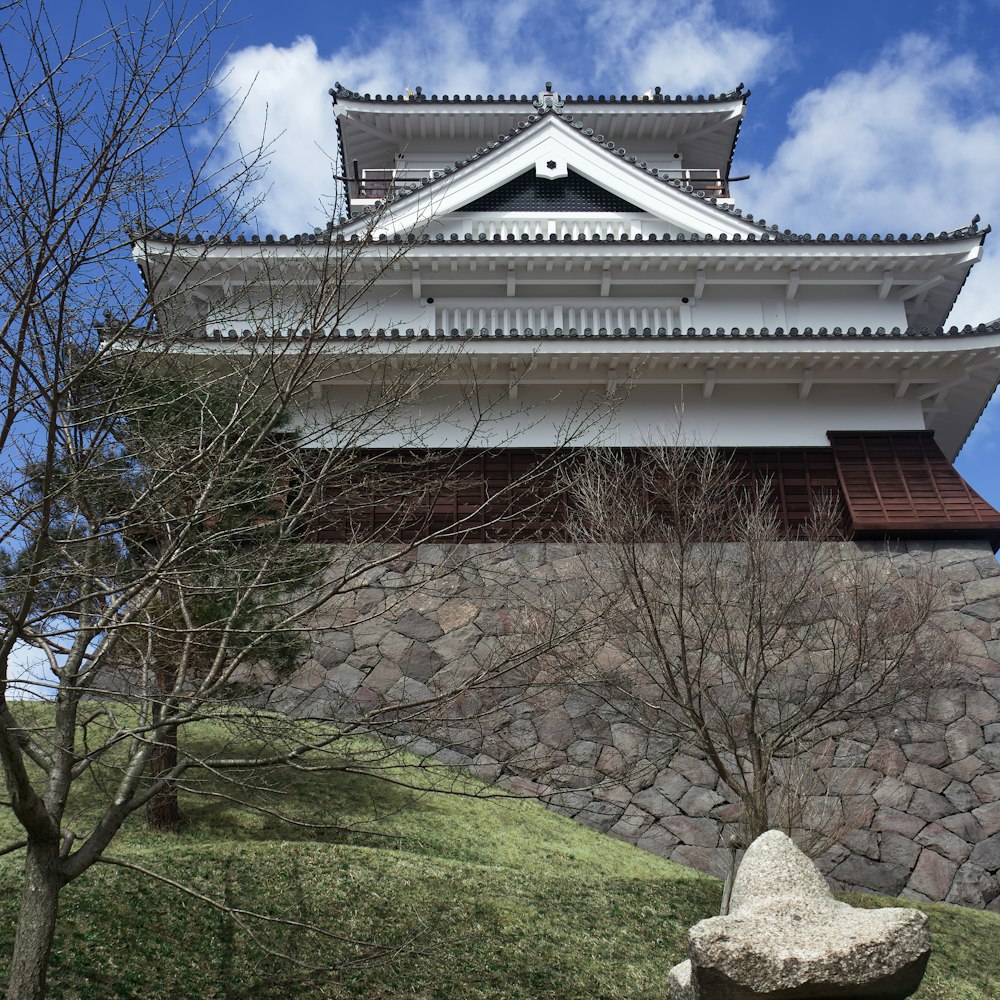 a stone wall with a building on top of it