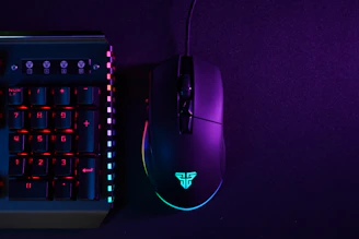 A sleek gaming keyboard glowing with neon blue and violet lights on a dark background.