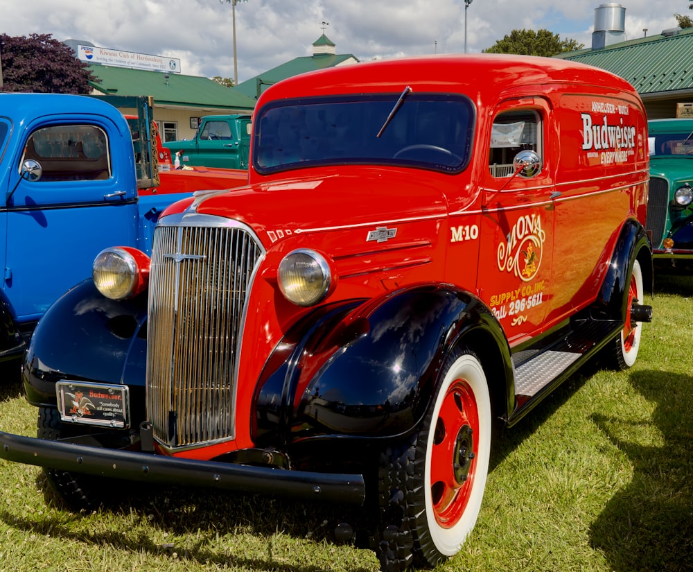 a red truck parked next to a blue truck