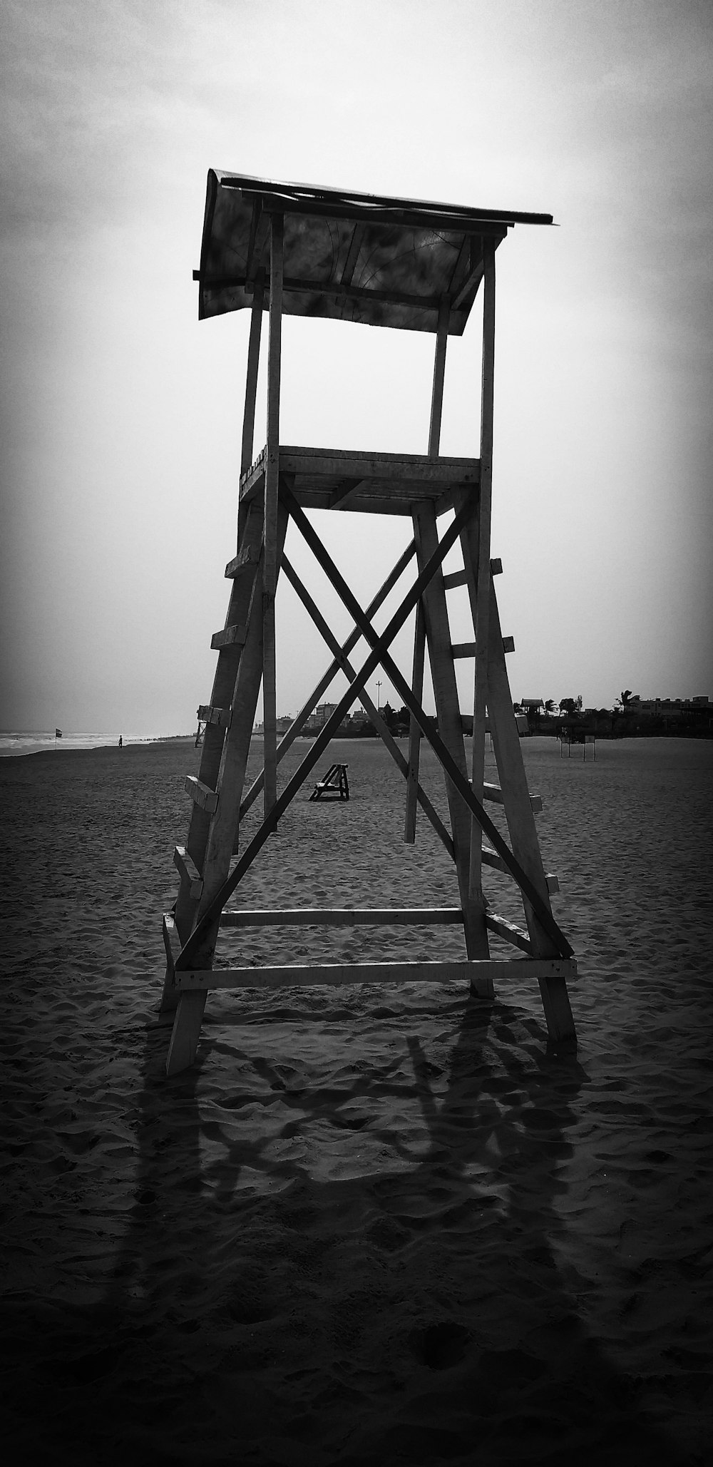 a lifeguard tower sitting on top of a sandy beach