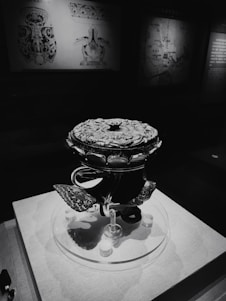 A vibrant 3D digital reconstruction of an ancient artifact displayed in a museum setting.