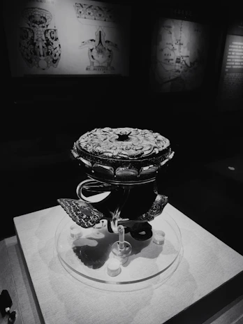 Close-up of a mysterious ancient artifact from a fantasy game, bathed in shadowy light.