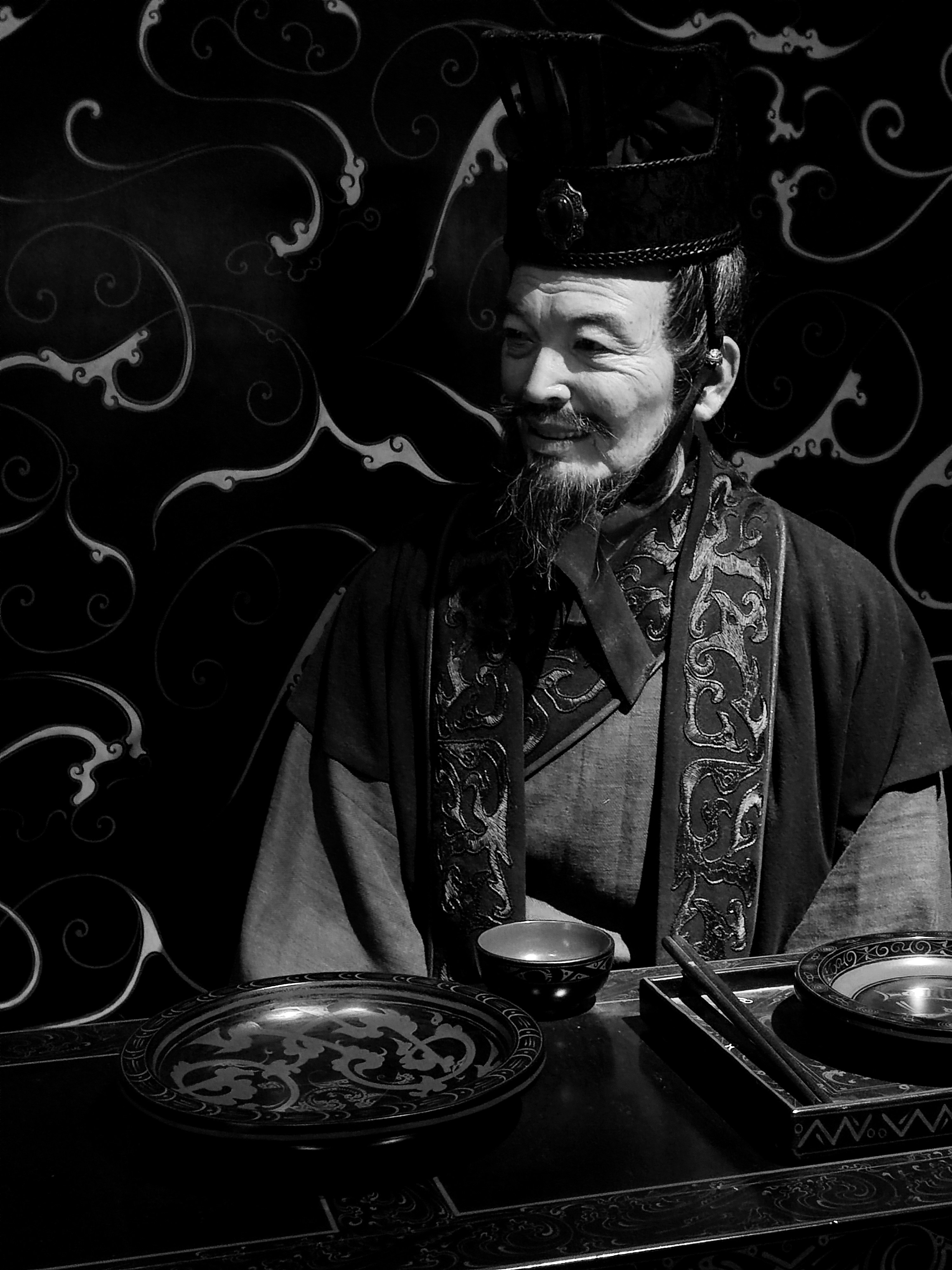 a man sitting at a table with a bowl of food