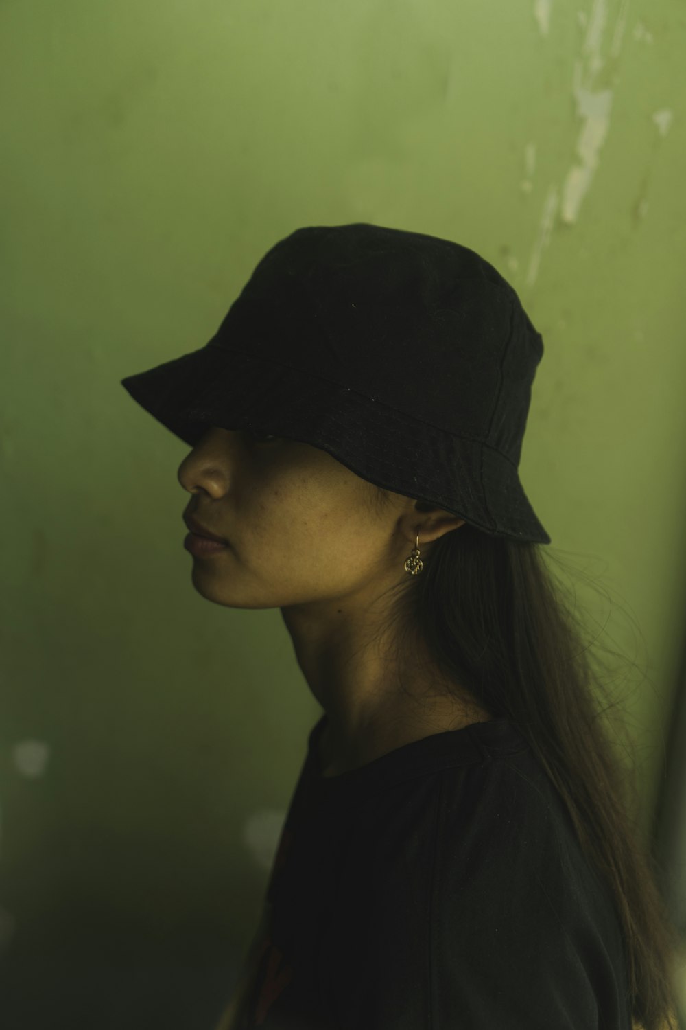 a woman wearing a black hat with long hair