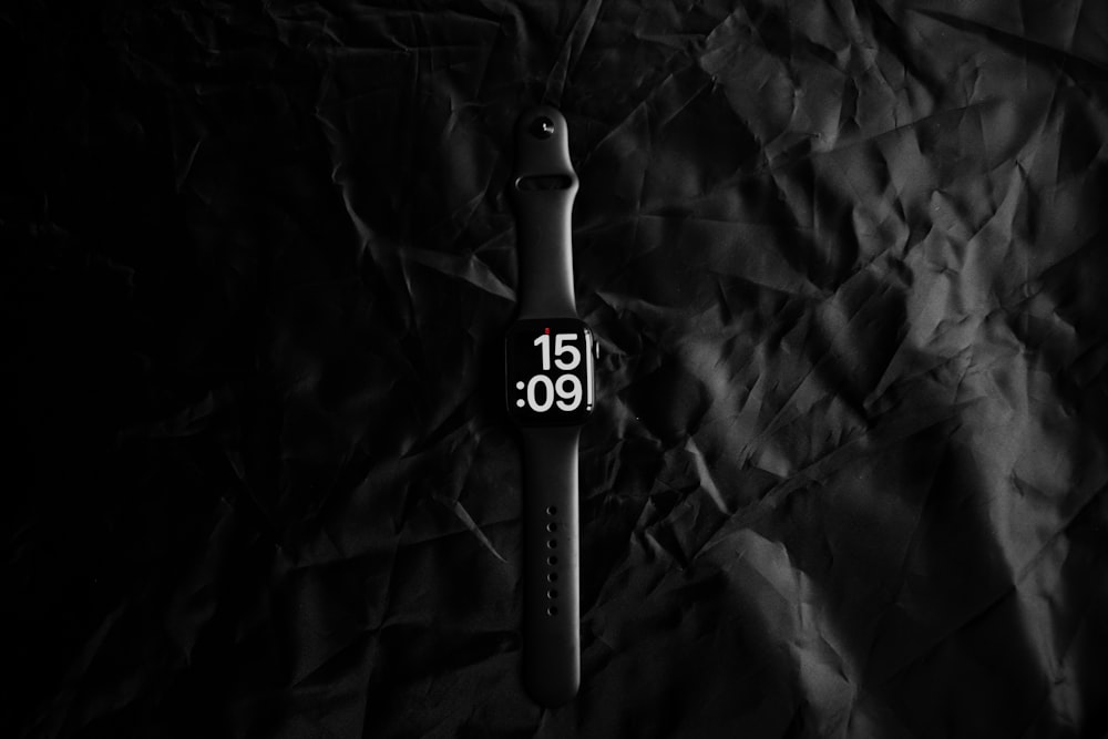a close up of a watch on a black background