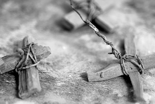 a black and white photo of two wooden crosses