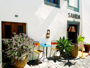 Outdoor patio space with comfortable chairs and a small table.