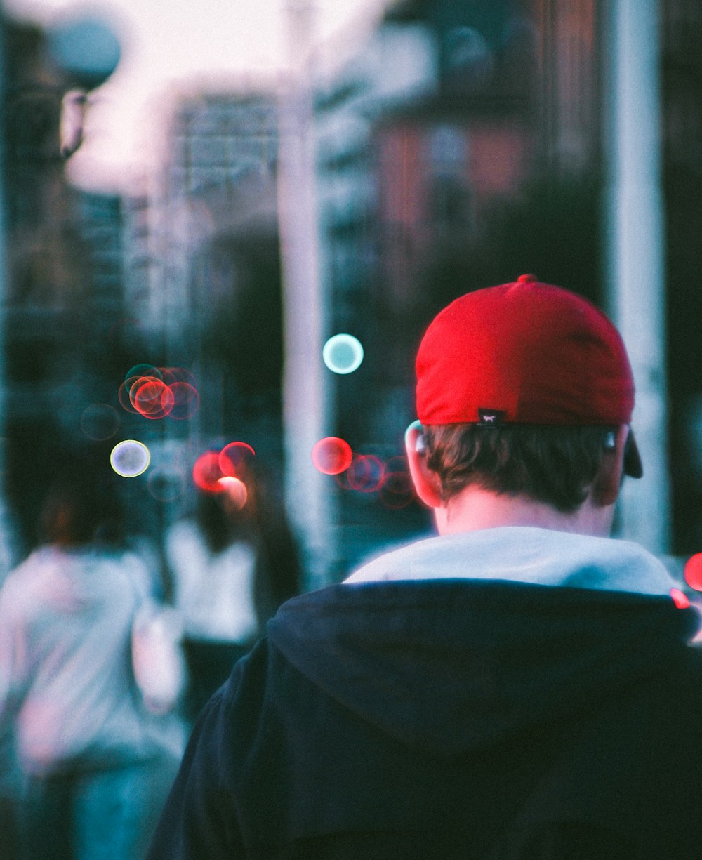 a man wearing a red hat and sunglasses