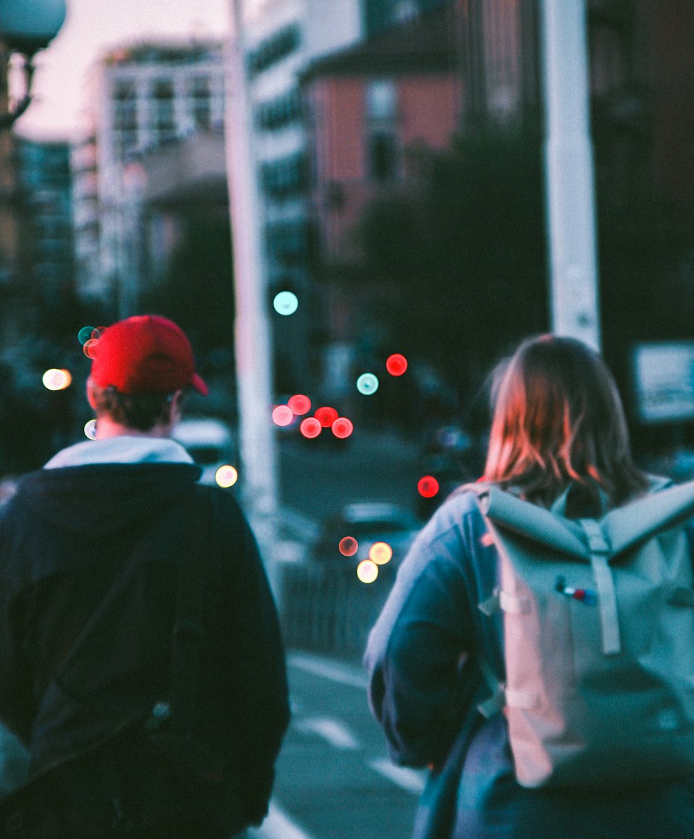 a couple of people walking down a street