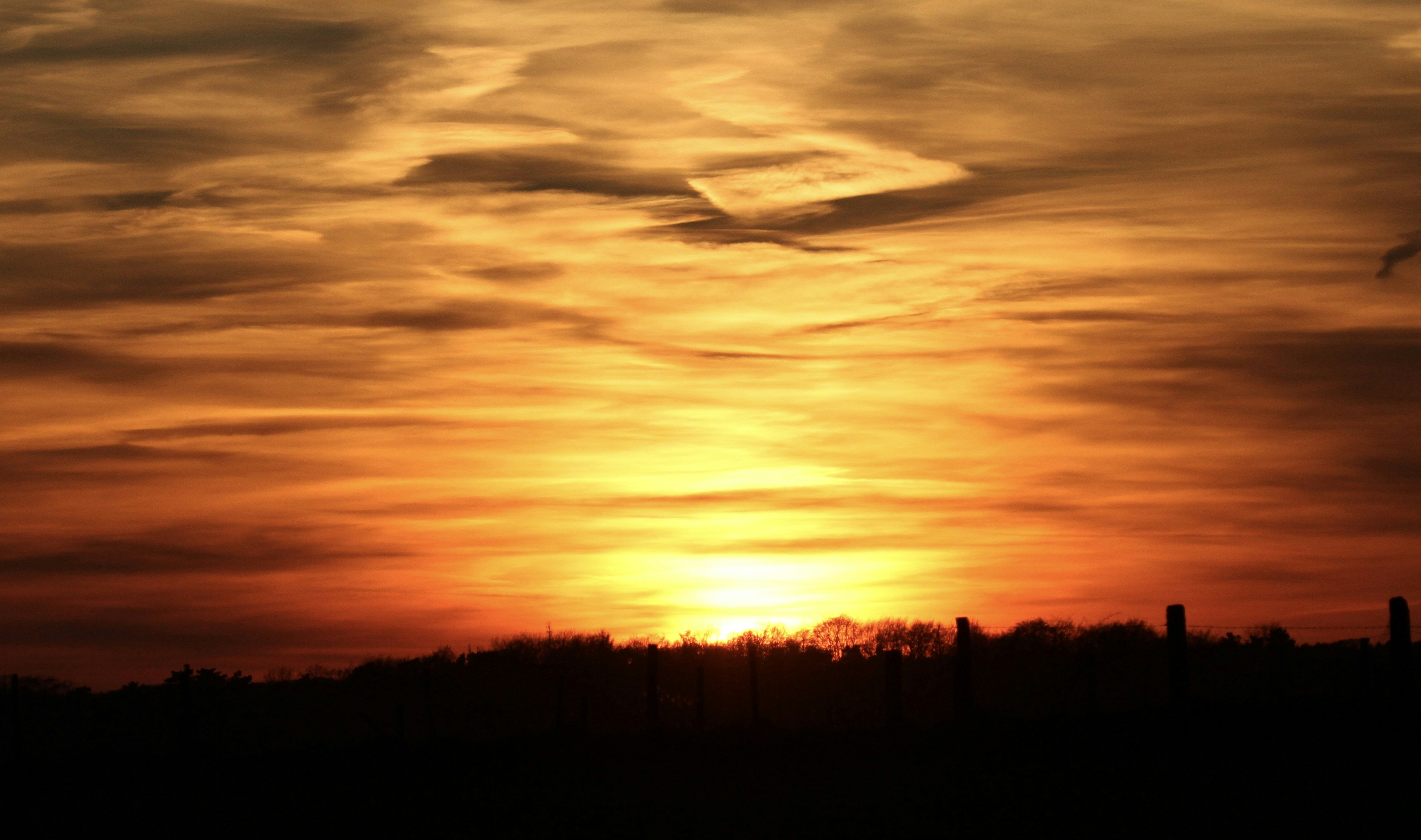 the sun is setting over the horizon of a city