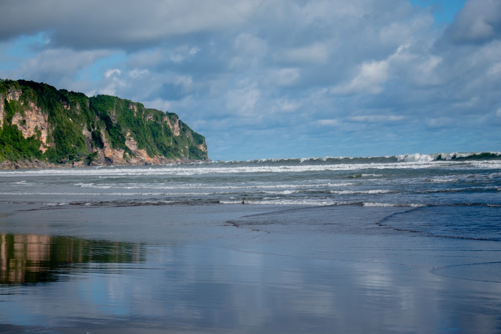 a large body of water sitting on top of a beach