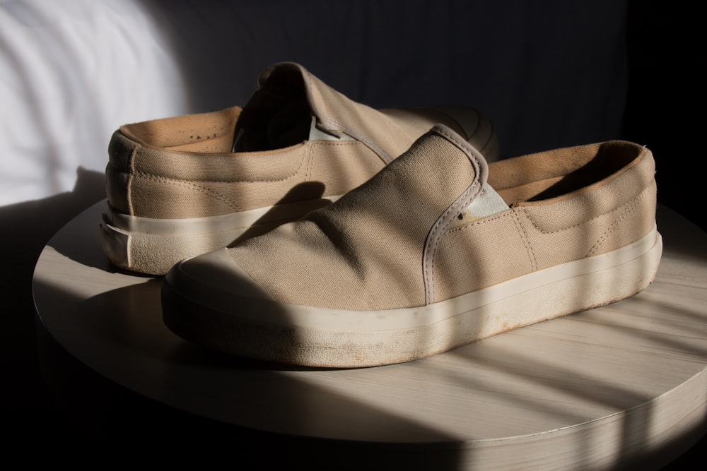 a pair of shoes sitting on top of a wooden table