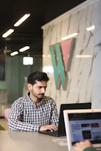 a man sitting in front of a laptop computer
