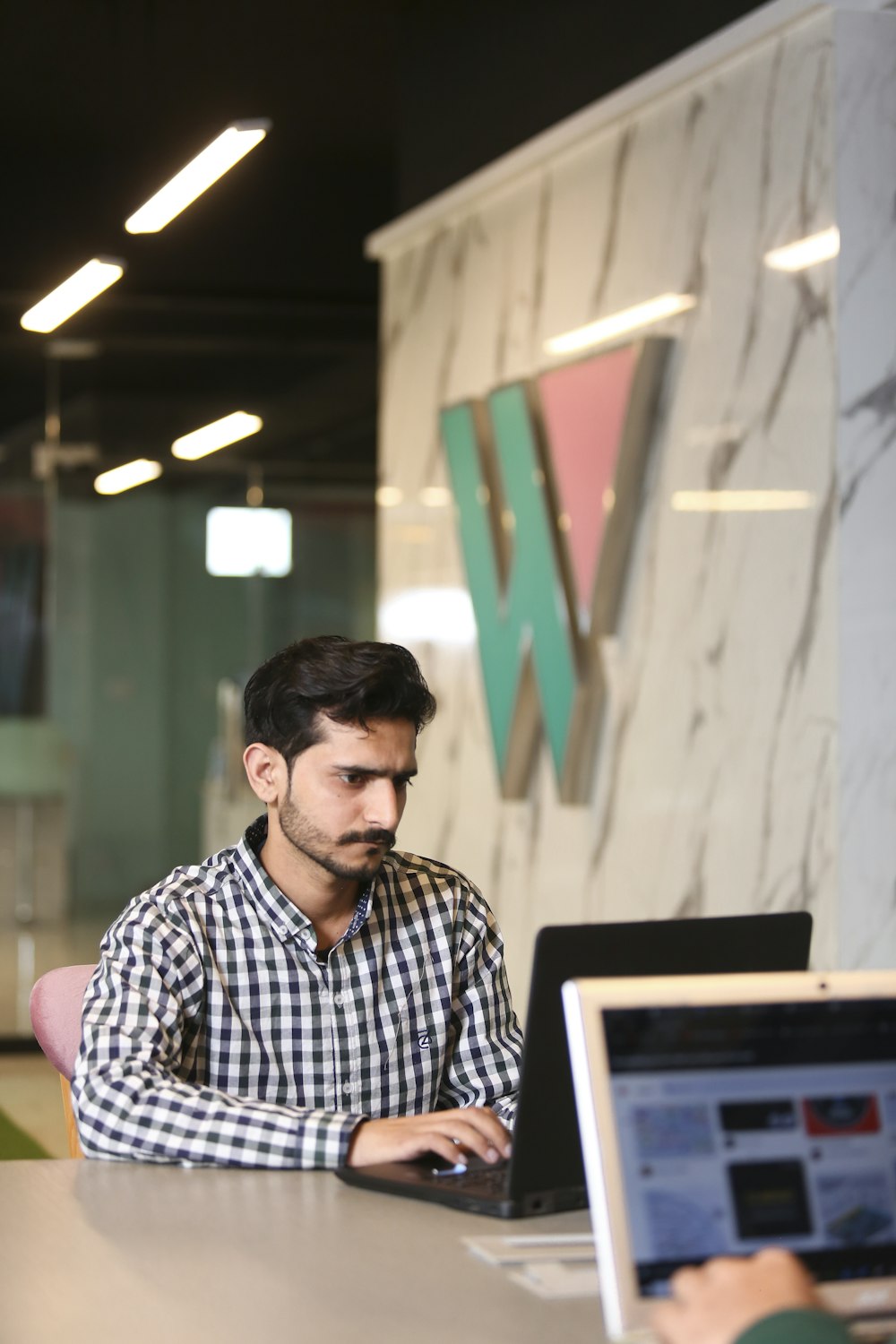 a man sitting in front of a laptop computer