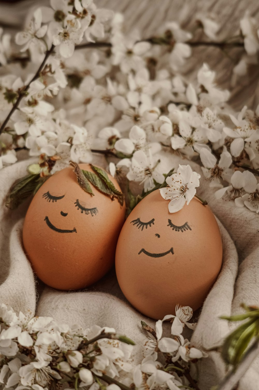 two eggs with faces drawn on them sitting next to each other