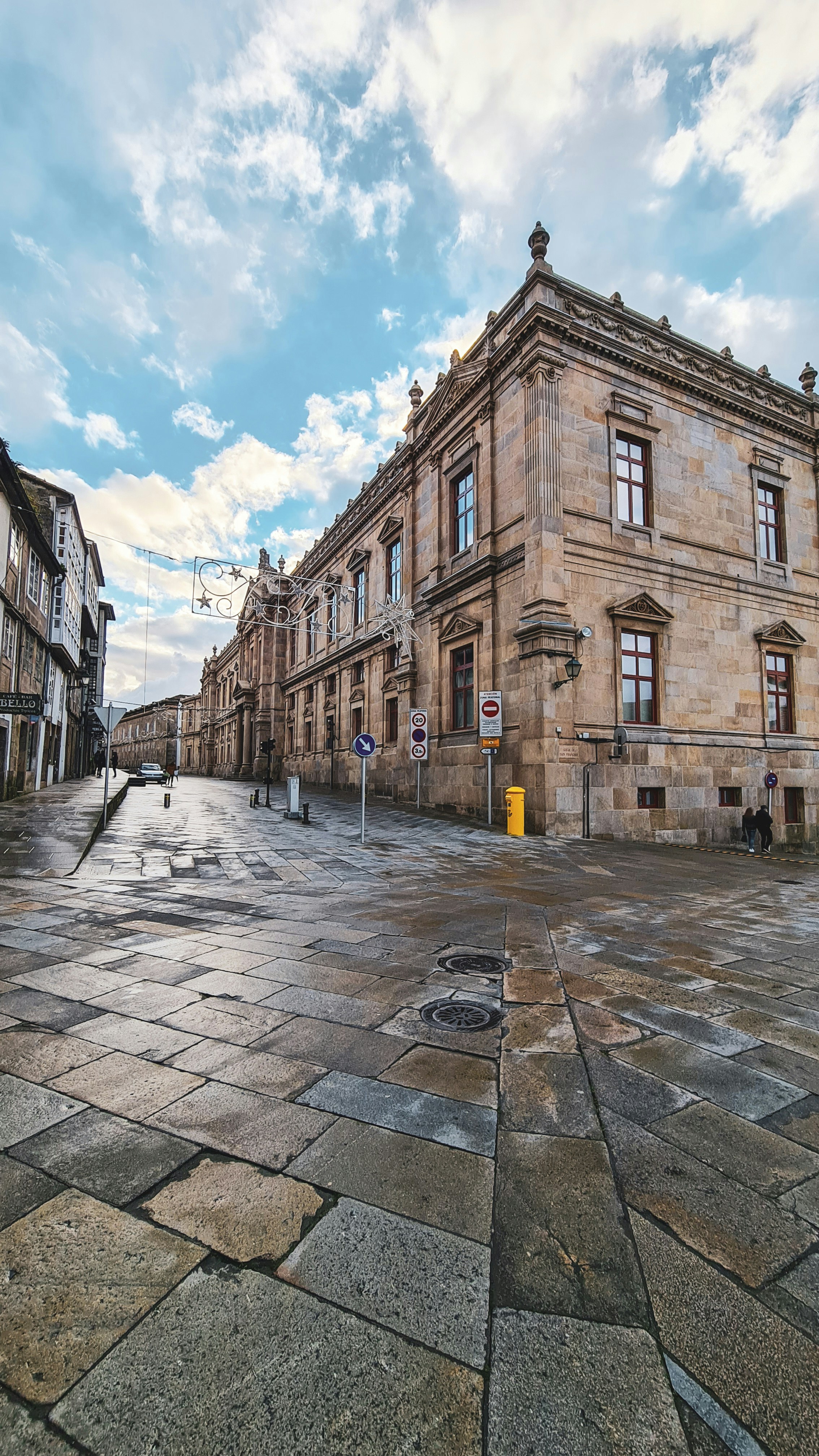 a large stone building sitting on the side of a road