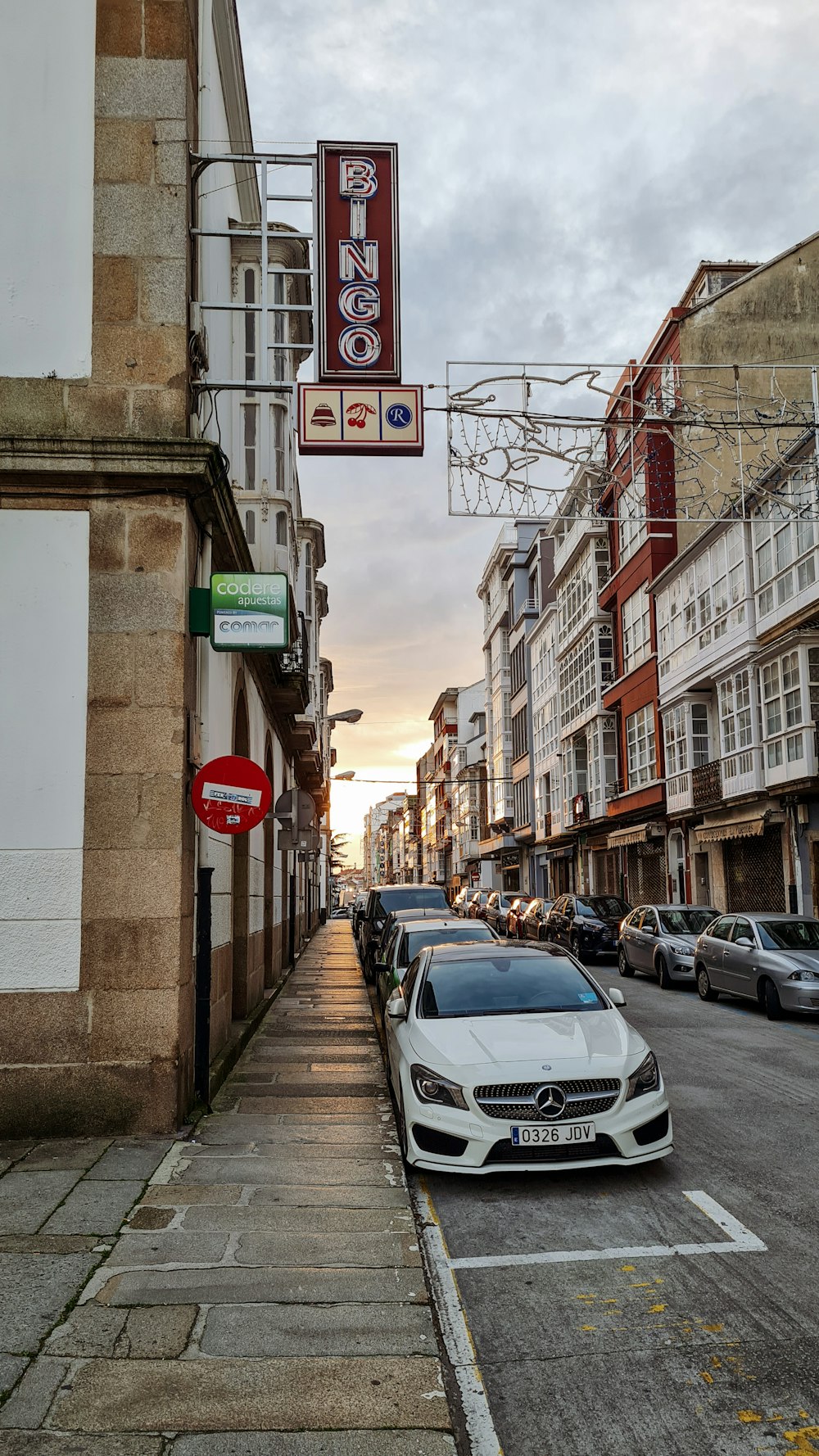 a white car parked on the side of a street