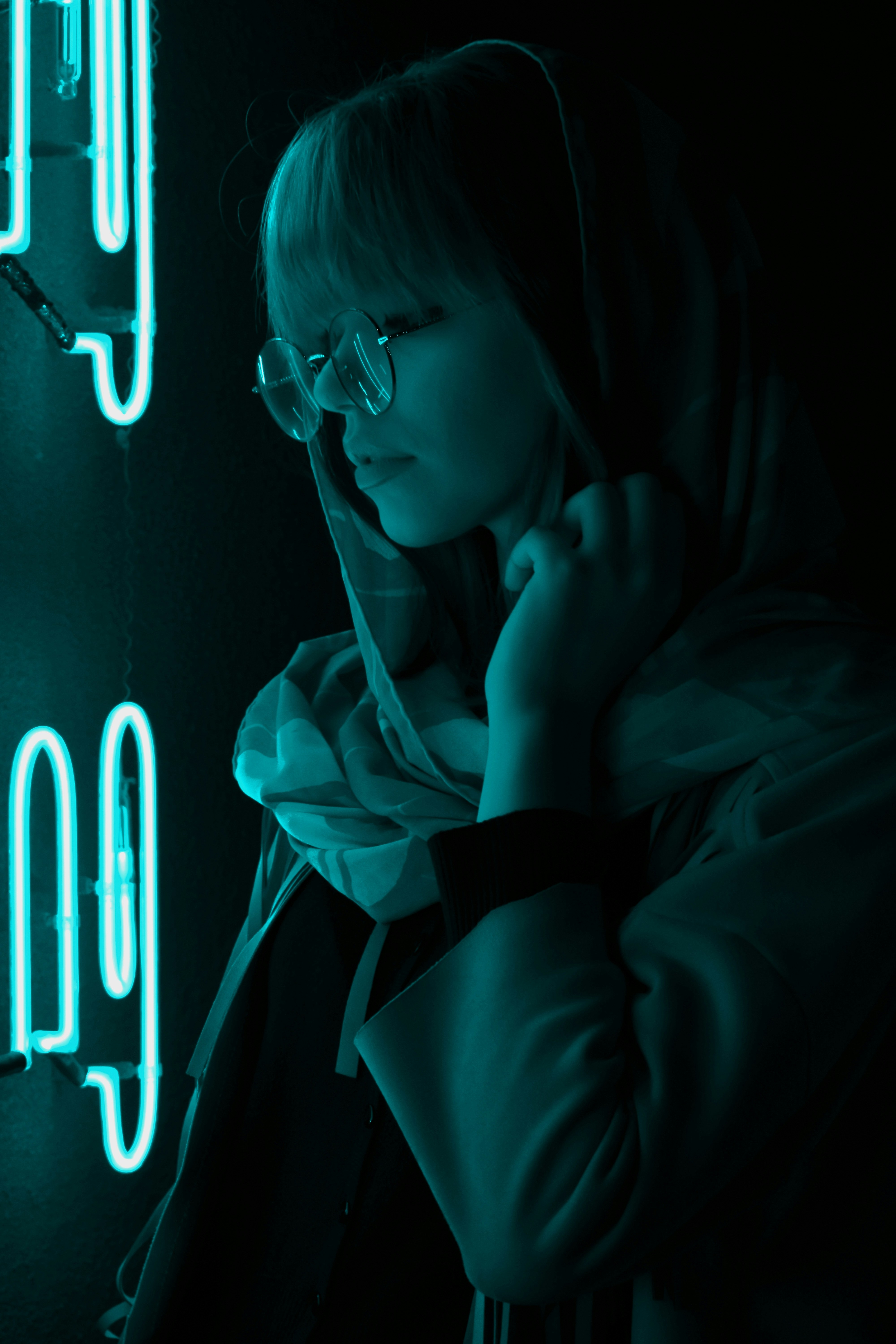 a woman standing in front of a neon sign