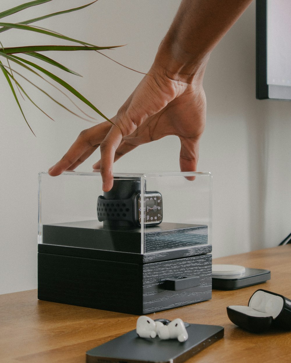 a person reaching for a remote control on a table