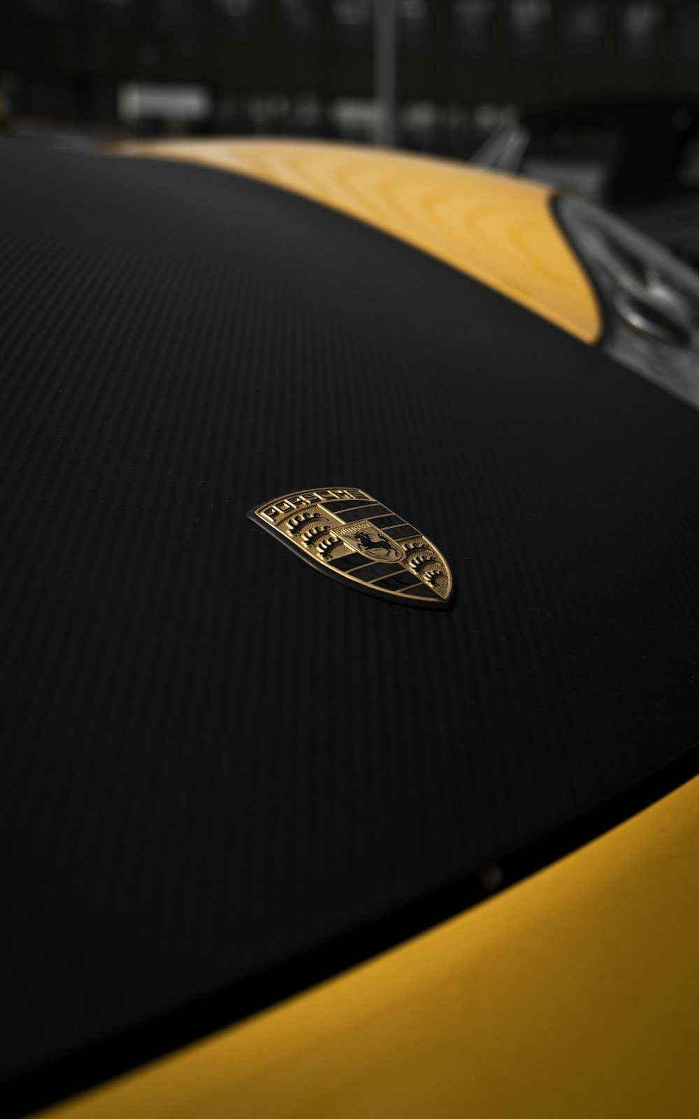 a close up of the hood of a yellow sports car