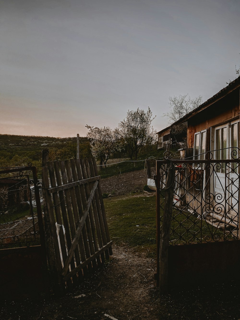 a house with a fence and a gate in front of it