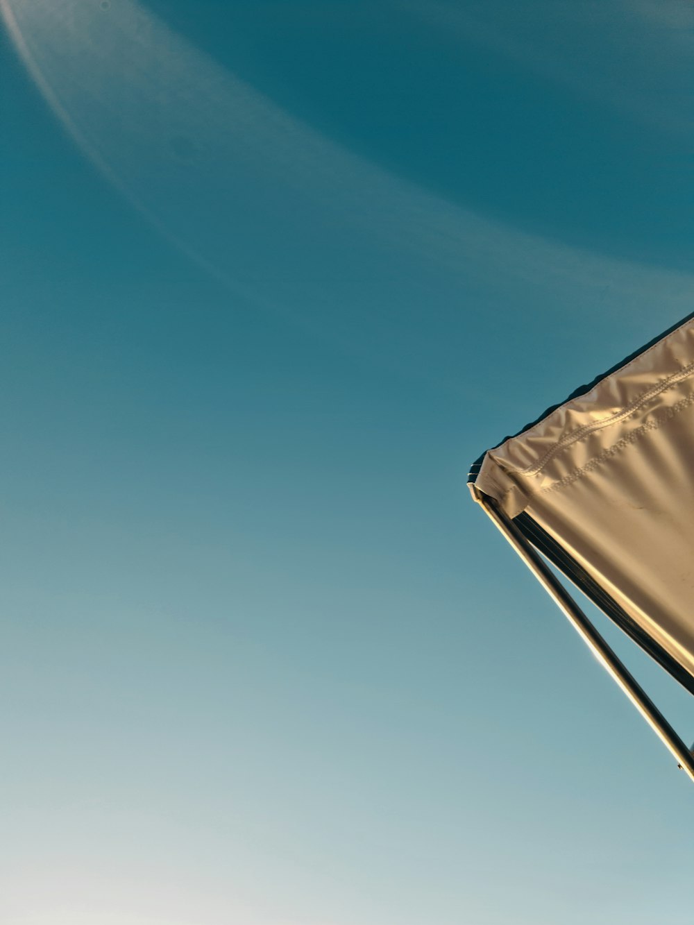 a kite flying in the air with a blue sky in the background