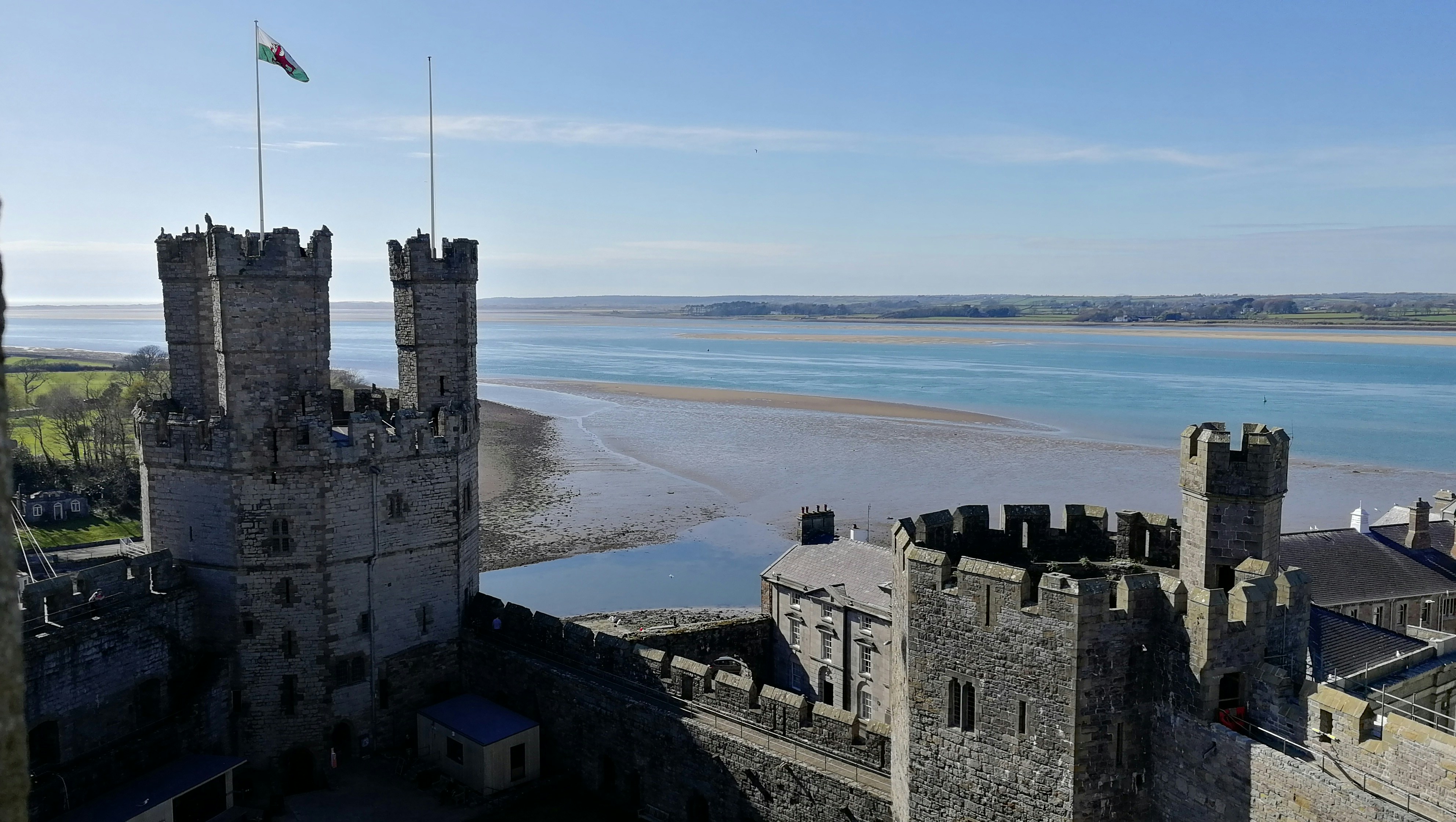 a castle overlooking a body of water on a sunny day