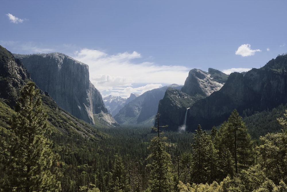 a view of a valley with mountains in the background