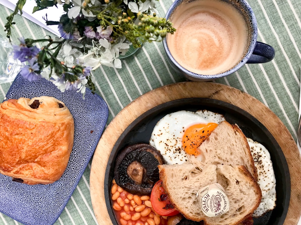 a plate of food and a cup of coffee on a table